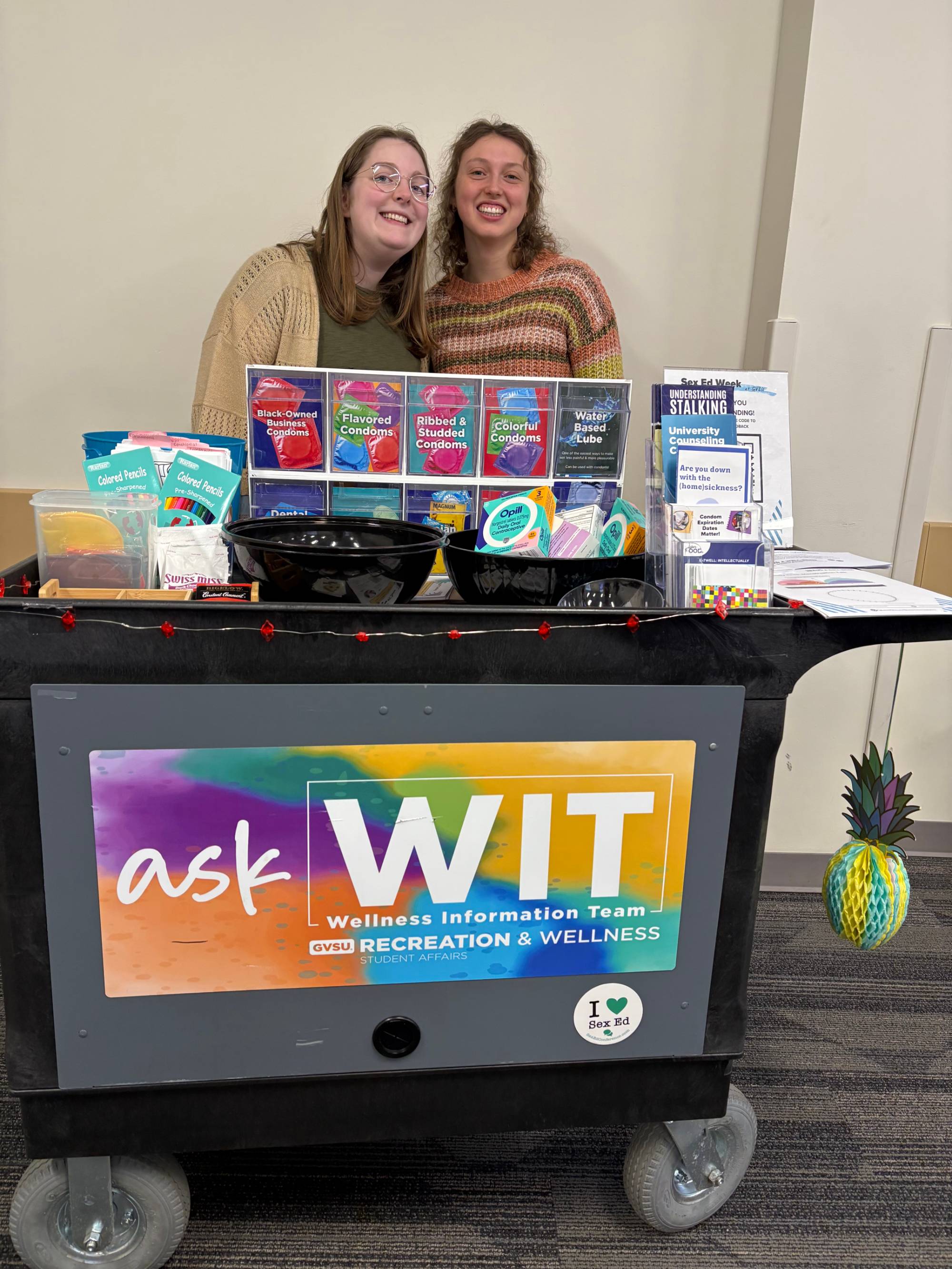 Image of two smiling people behind the wit cart